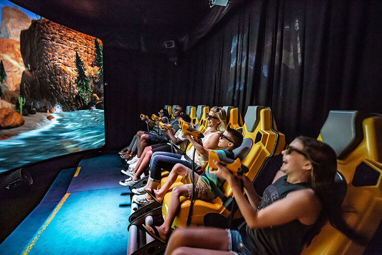 A photo of people of all ages enjoying a XD Dark Ride experience